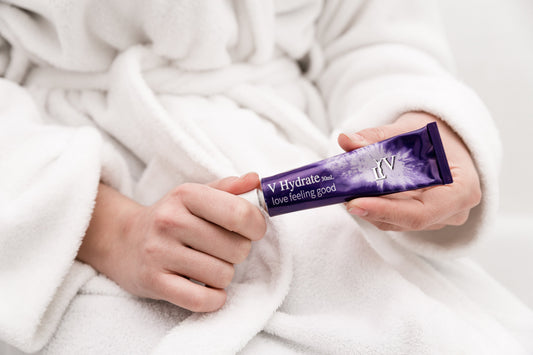 LYV V-Hydrate intimate moisturiser tube, held in a robe